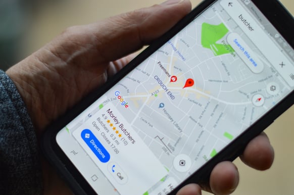 person holding smartphone with map